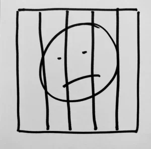 A hand-drawn face, behind jail bars